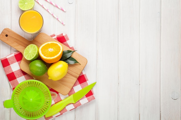 Citrus fruits and glass of juice Oranges limes and lemons