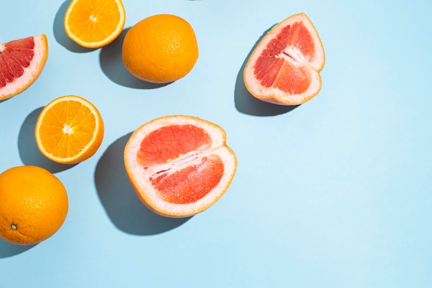 Citrus fruits, oranges, grapefruit on a blue background. Top view, flat lay.