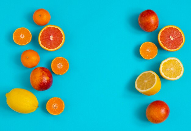 Citrus fruits oranges tangerines lemons blood oranges on a blue background