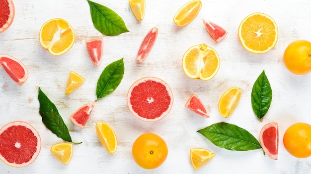 Citrus fruits on white wooden background Top view Free copy space