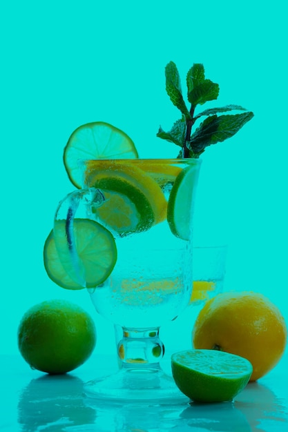 Citrus infused water non alcohol cocktails with orange lemon and lime on a colored background Refreshing summer cocktails Closeup