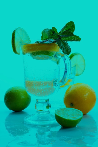 Citrus infused water non alcohol cocktails with orange lemon and lime on a colored background Refreshing summer cocktails Closeup