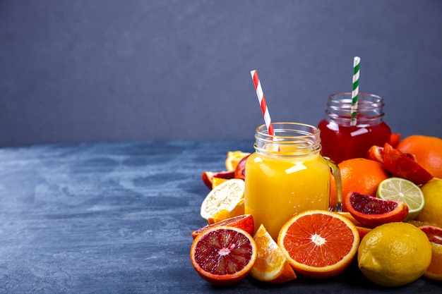 Citrus juices on concrete background