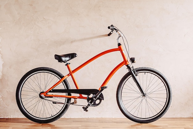 A city bicycle near a plastered wall