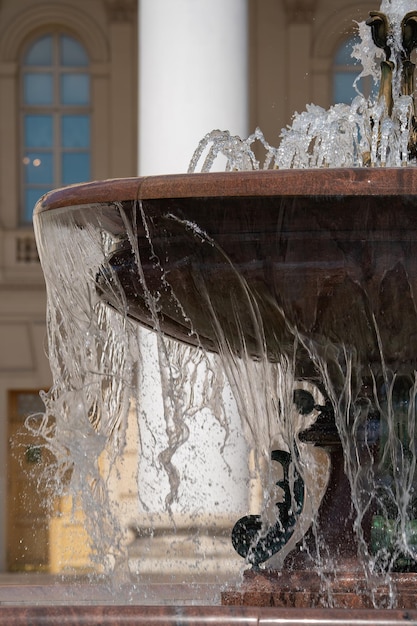 city fountain with granite bowl on a bright sunny day