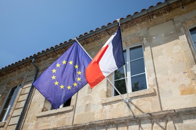 City hall facade with european and french flags on town hall entrance in village France