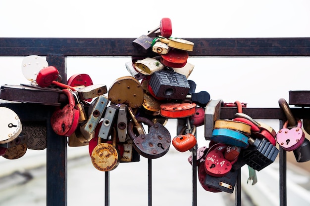 City landscape Metal bridge with a lot of colorful locks Wedding Traditions