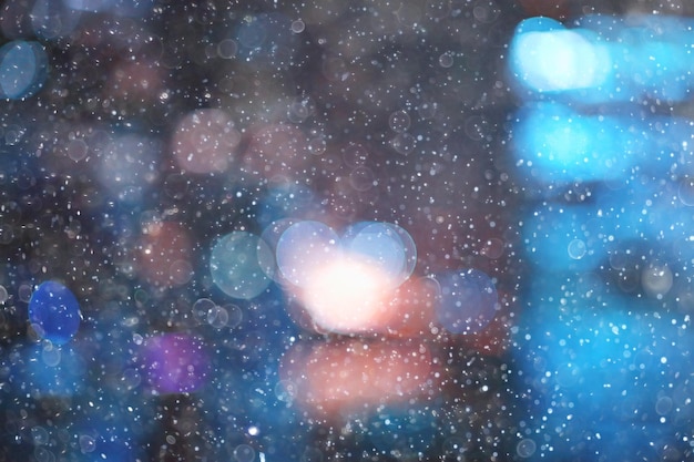 city lights snow glow background blurred / cityscape blurred bokeh, snowy weather seasonal background winter December