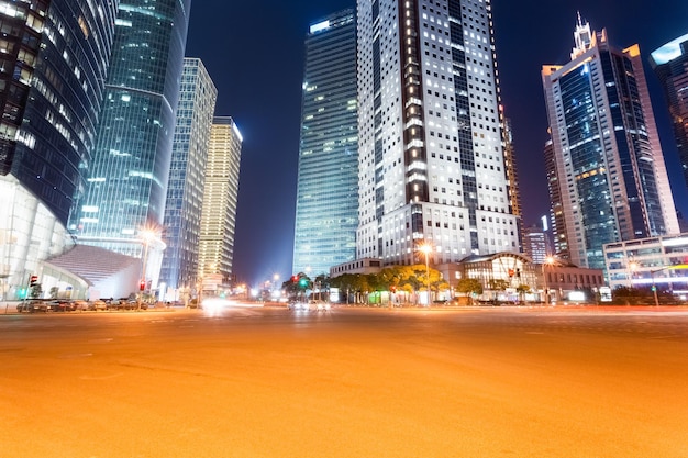 City road with modern office buildings at night in shanghai financial and trade zone