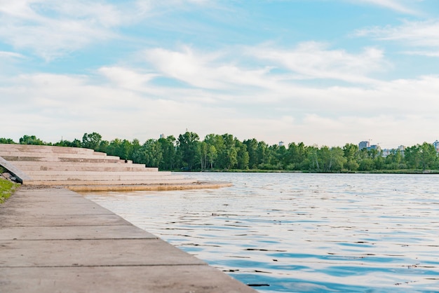 City's public lake with concrete borders and stairs on the bank Water Lake Landscape Park Scenery Grass Garden Outdoor Travel Leaf Sunny Environment Forest