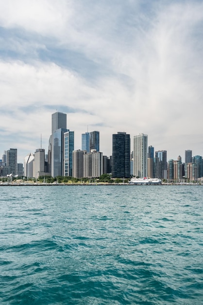 City skyline by sea against sky