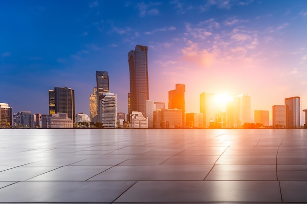 a city skyline with a sunset in the background