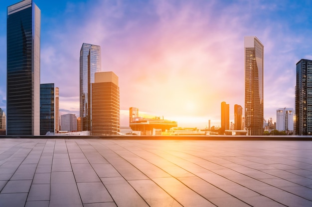 a city skyline with a sunset in the background