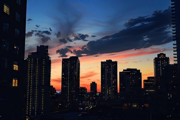 a city skyline with a sunset in the background