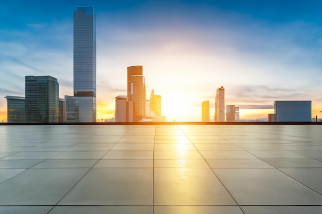 a city skyline with a sunset and a cityscape in the background