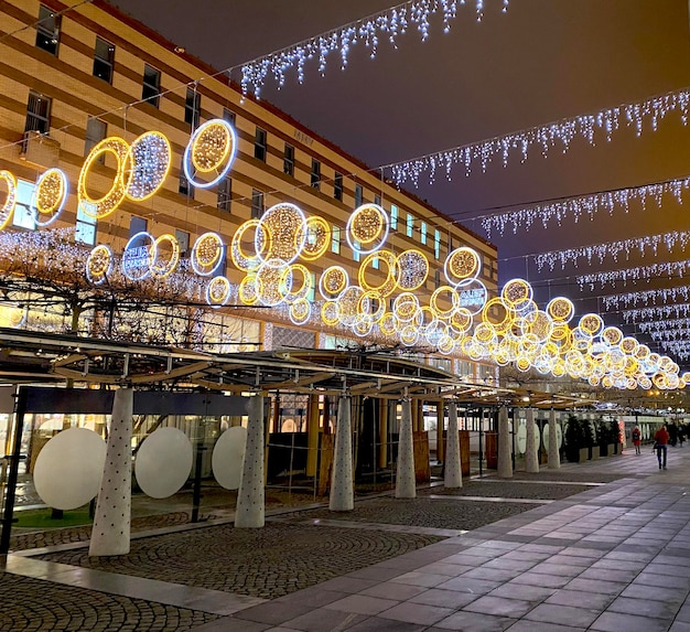 The city street is decorated for Christmas and New Year holidays. Kindred lights on the street