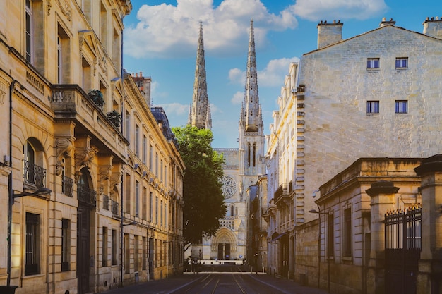 City street scene with tram rails and Saint Andre Cathedral on the back in Bordeaux France