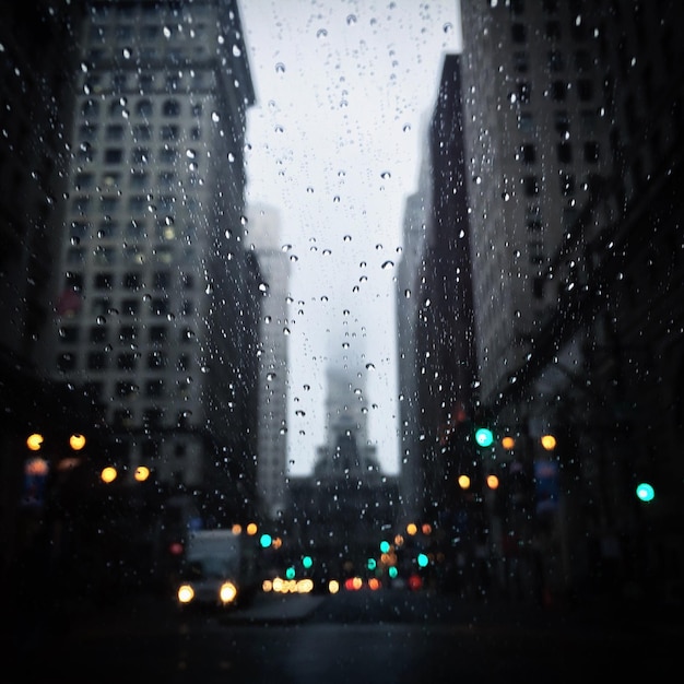 City street seeing through wet window