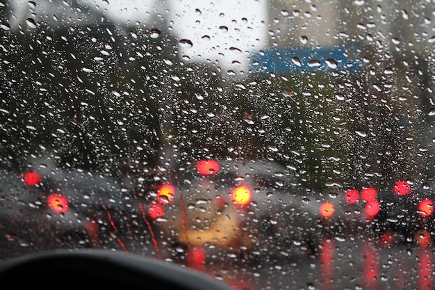 City Street Traffic Through Wet Car Windshield