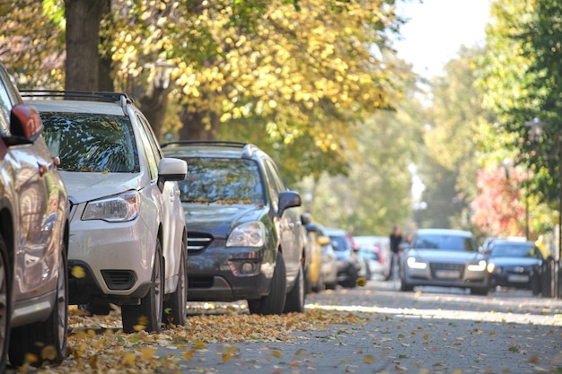 City traffic with many cars parked in line on street side