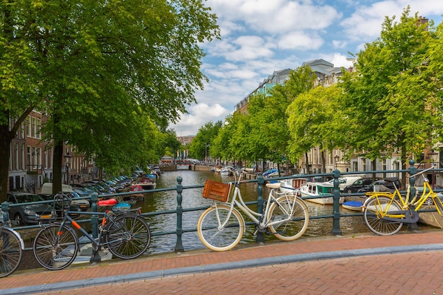 City view of amsterdam canal bridge and bicycles holland netherlands