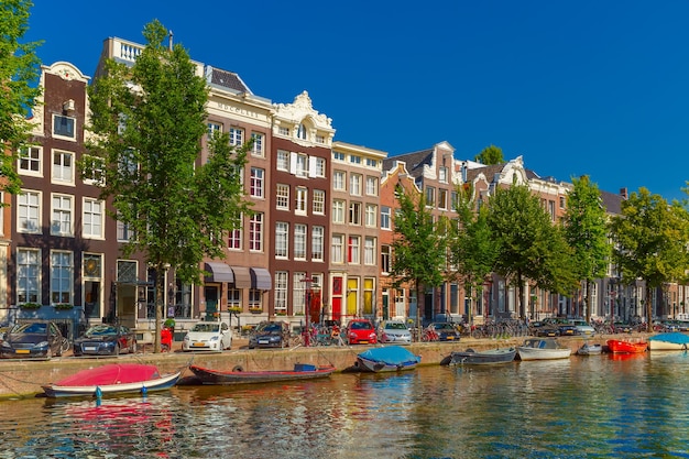 City view of Amsterdam canals and typical houses, boats and bicycles, Holland, Netherlands.