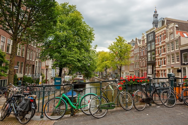 City view of Amsterdam canals and typical houses, boats and bicycles, Holland, Netherlands.