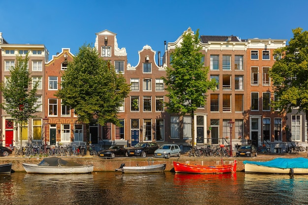 City view of Amsterdam canals and typical houses, boats and bicycles, Holland, Netherlands.