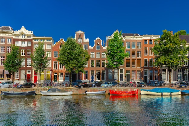 City view of Amsterdam canals and typical houses, boats and bicycles, Holland, Netherlands.