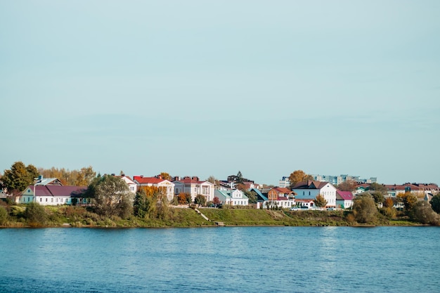 City view on sunny day Houses stand on the banks of the river Countryside