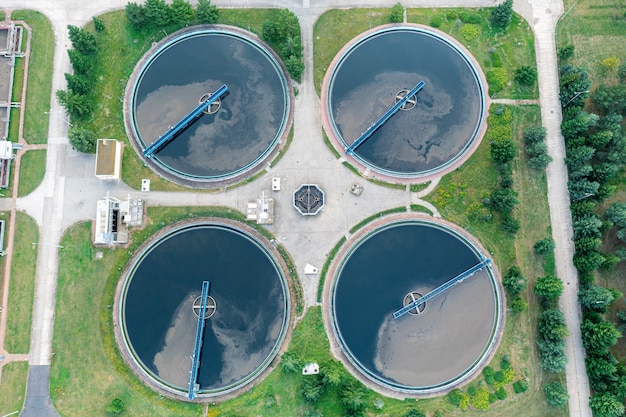 City water purification. Wastewater flows through large circular tanks with power-driven scrapers. View from above