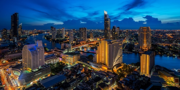 Cityscape in Bangkok city from roof top bar in hotel with Chao phraya river