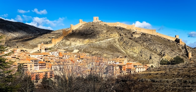 Cityscape of the city of Albarracin with its medieval wall that surrounds the city above the mountain. Teruel, Spain. Europe.