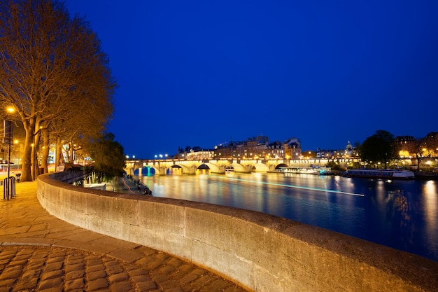 CItyscape of downtown with Pont Neuf Bridge and River Seine at night Paris