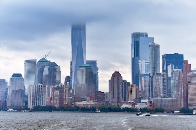 Cityscape of the financial district of Manhattan from Liberty Island, in a foggy day.