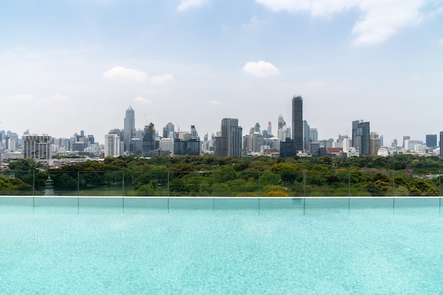 Cityscape and high-rise buildings in metropolis city with water reflection