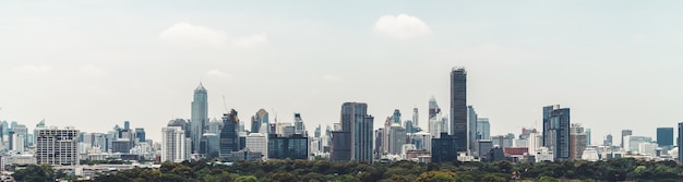 Cityscape and high-rise buildings in metropolis city with water reflection