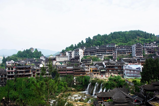 Cityscape historic building antique architecture of Furong Zhen Tujia ancient town with landscape mountain waterfall and youshui river for chinese travelers travel visit on May 9 2024 in Hunan China