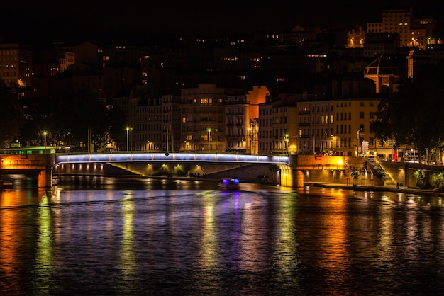 Cityscape of Lyon France with reflections in the water at night