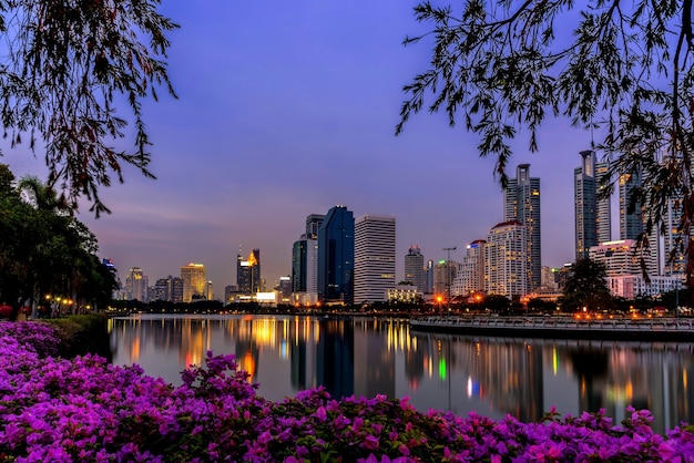 Cityscape at night at the park with commercial building,Bangkok,Thailand.