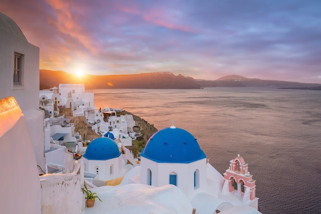 Cityscape of Oia town in Santorini island, Greece. Panoramic view at the sunset.