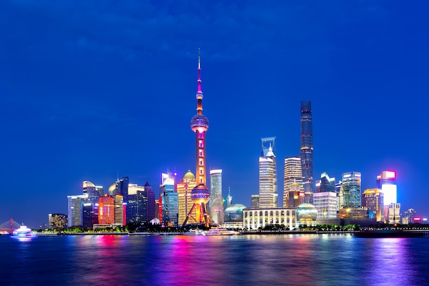 Cityscape of Shanghai at twilight sunset. Panoramic view of Pudong business district skyline from the Bund.