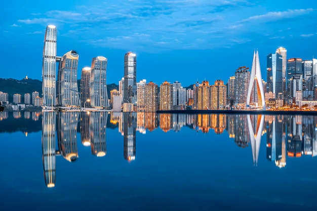 Cityscape and skyline of downtown near water of chongqing at night