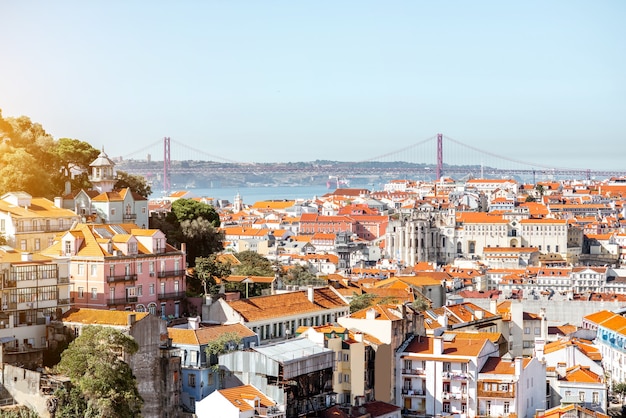 Cityscape view on the Lisbon city with famous bridge during the sunny day in Portugal