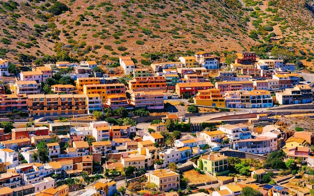 Cityscape with Buggerru city with cottage house architecture at the Mediterranean Sea in South Sardinia in Italy. Sardinian Italian small town in Sardegna.