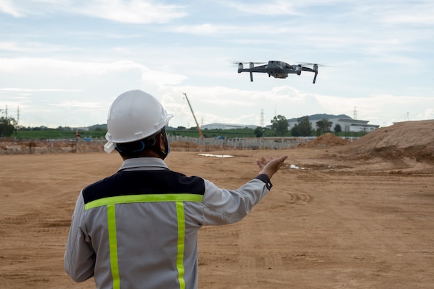 Civil engineer control the drone for inspection construction work