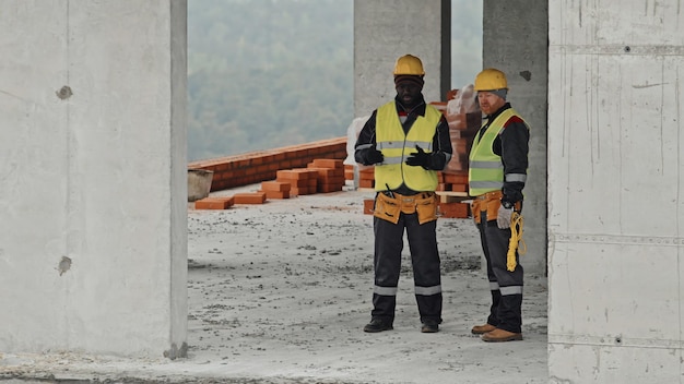 Civil engineers discussing problem with communications installation on construction site