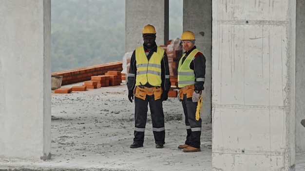 Civil engineers discussing problem with communications installation on construction site