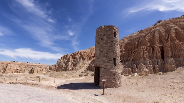 Civilian conservation corps water tower and rock formation in the desert