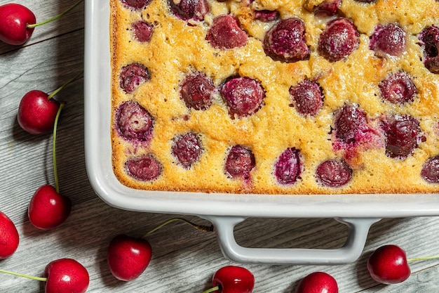 Clafoutis cherry tart traditional french pie in a baking dish top view